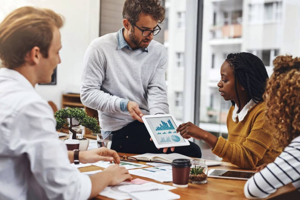 Group of managers in an office discussing brand strategy vs internal comms strategy